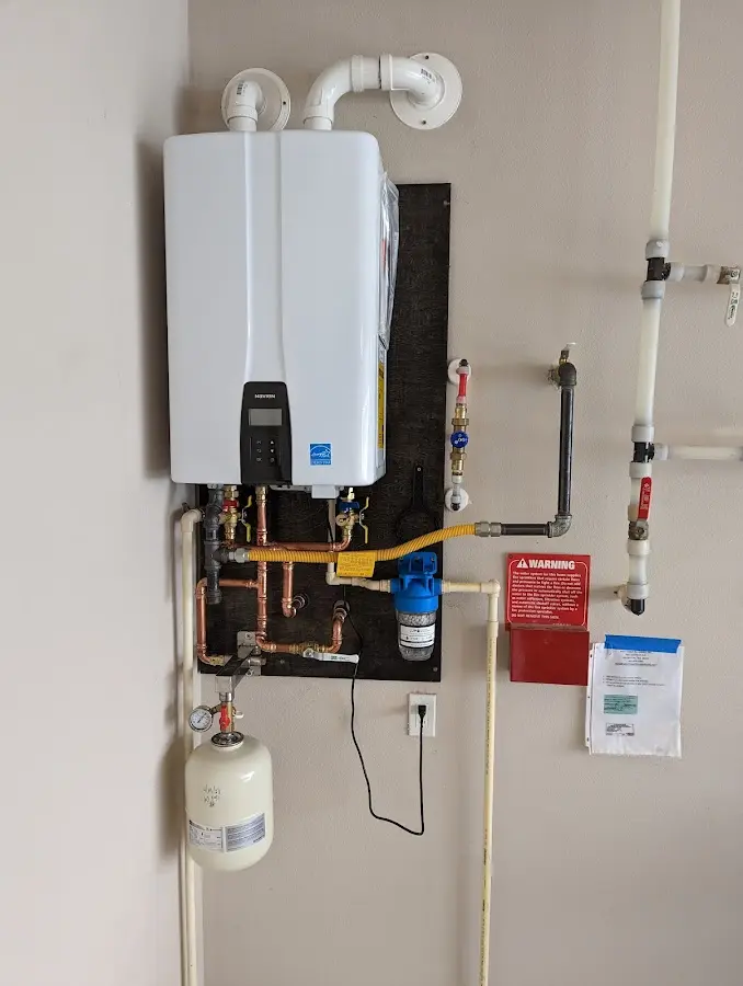 Professional plumber installing copper piping in a Rosedale home